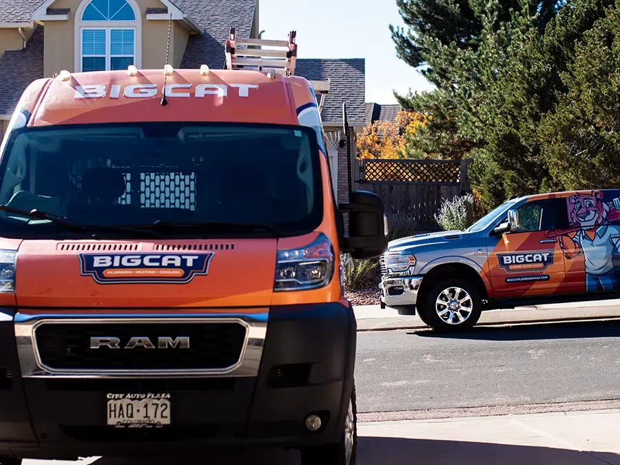 Big Cat plumbing heating & cooling trucks in neighborhood