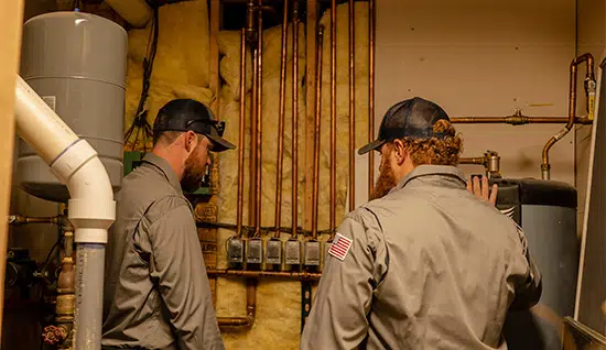 techs inspecting water heater in colorado springs