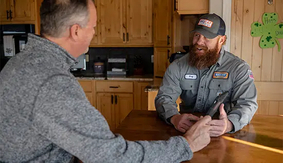 Colorado Springs HVAC tech talking to customer