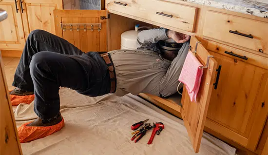 plumber fixing garbage disposal in Colorado Springs, CO