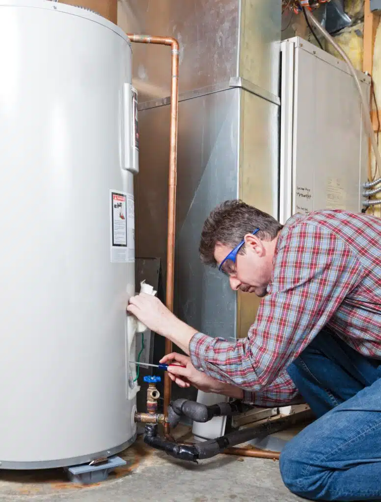 A Colorado Springs plumber demonstrating how to drain a hot water heater safely.