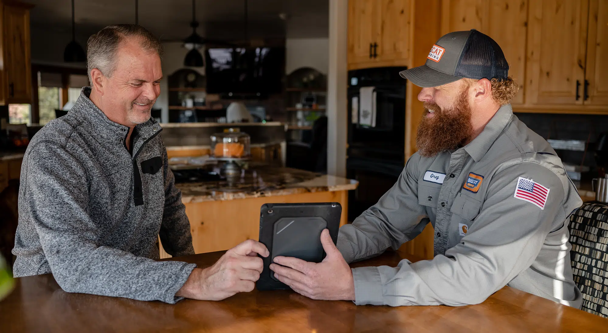 Technician helping customer at dining room table in Colorado Springs, CO.