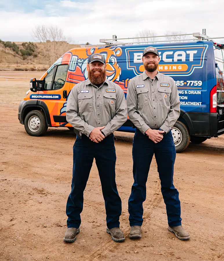 Big Cat Plumbing, Heating, and Cooling technicians in front of fleet vans in Colorado Springs, CO.
