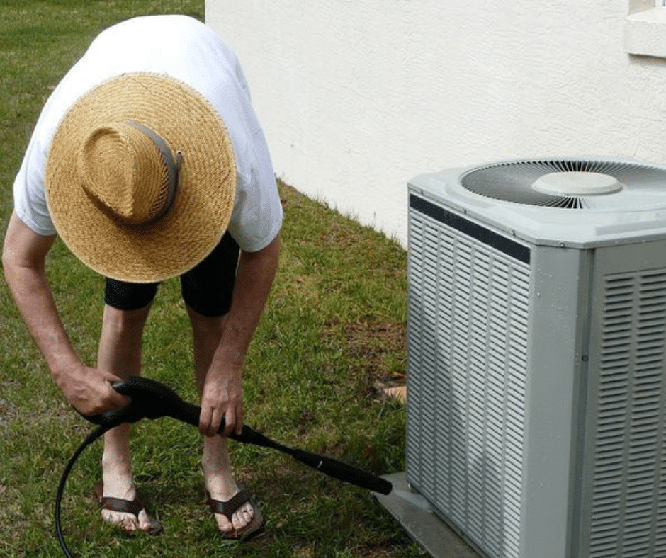 woman cleaning AC condenser