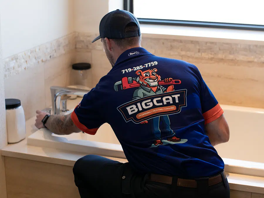 Big Cat plumber working on bathtub