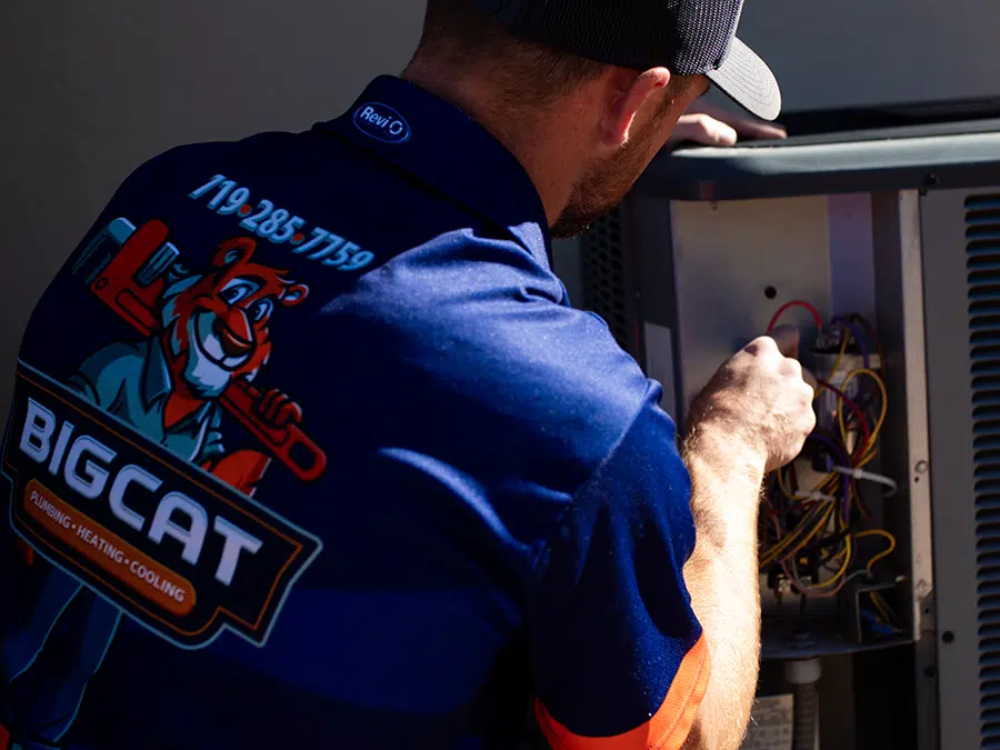 Big Cat tech fixing outdoor AC unit