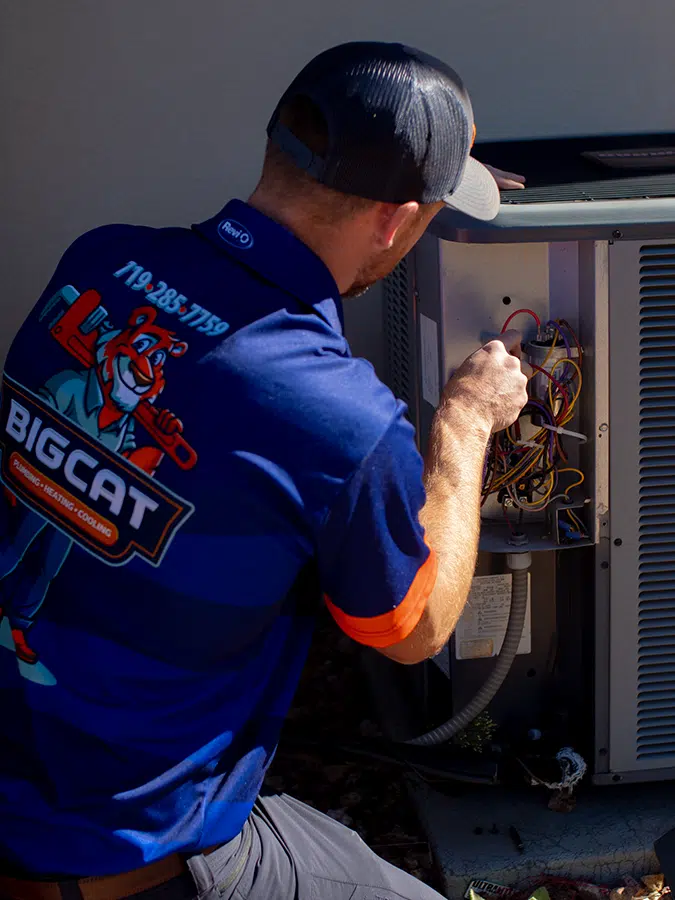 Big Cat tech fixing outdoor AC unit