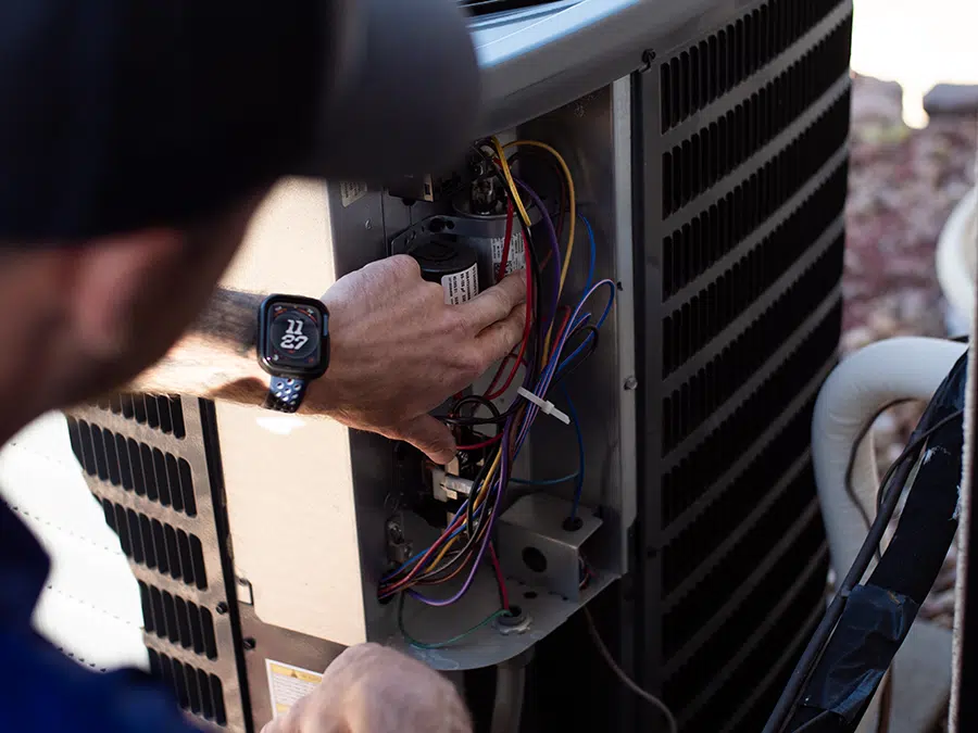 Big Cat tech fixing outdoor AC unit
