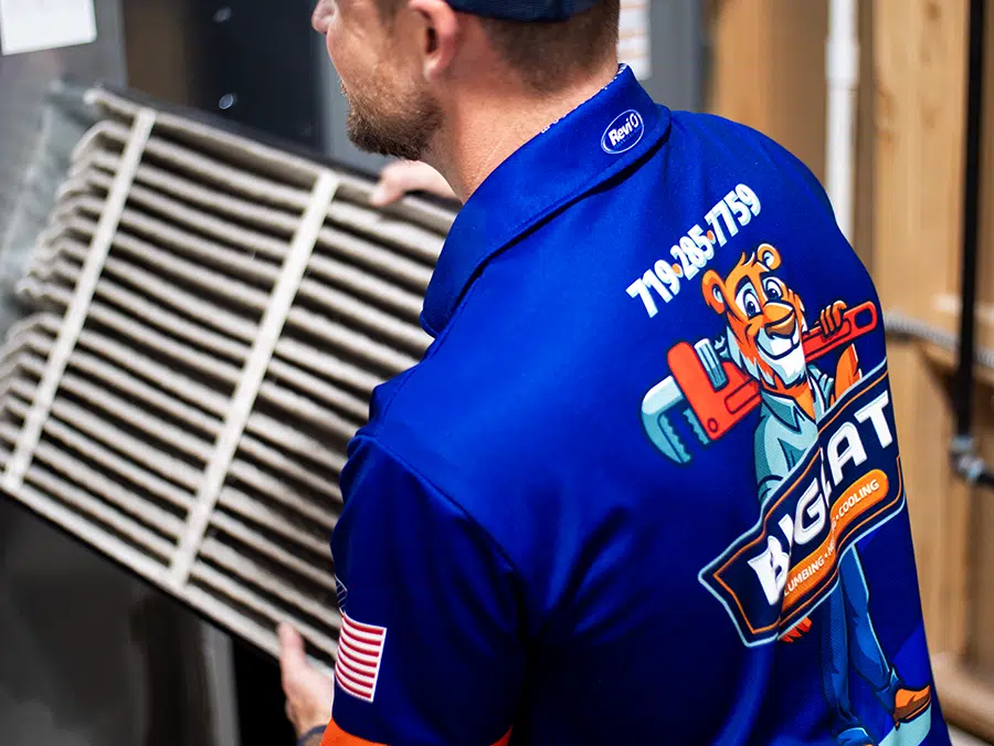 technician changing furnace filter in Colorado Springs, CO.