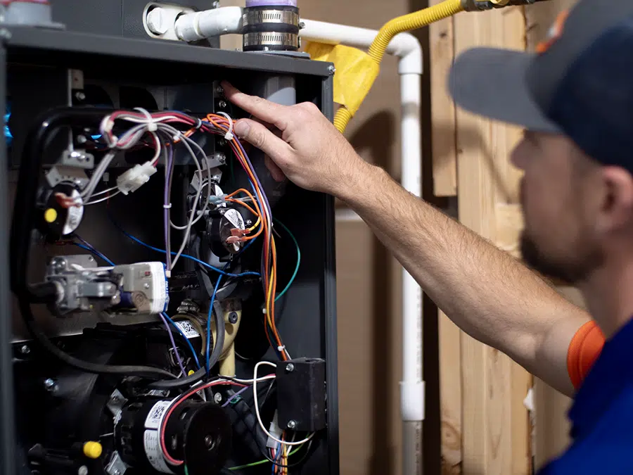 Technician repairing furnace