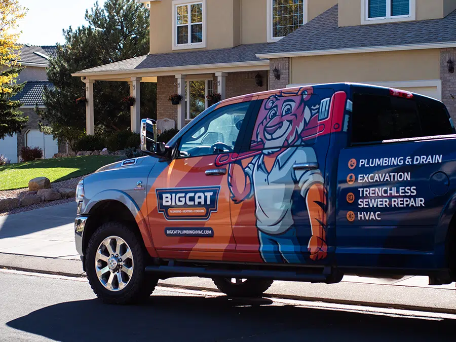 Big Cat plumbing heating & cooling truck in neighborhood