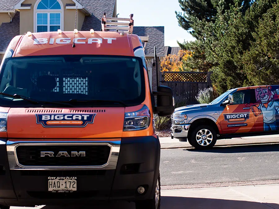 Big Cat plumbing heating & cooling trucks in neighborhood
